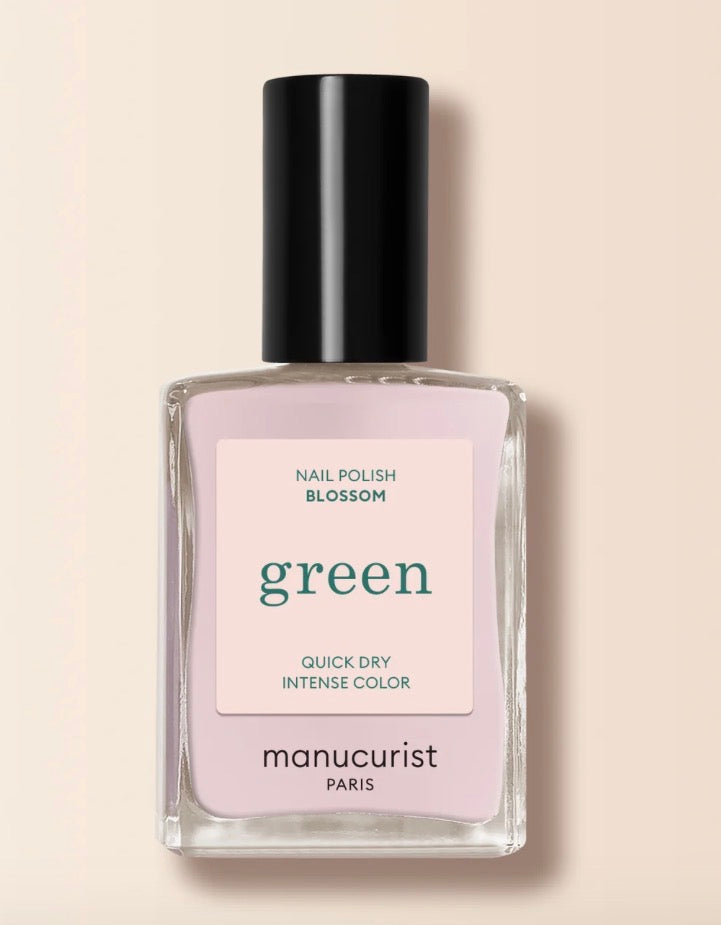 Manucurist nail polish bottle labeled 'Green' on a beige background