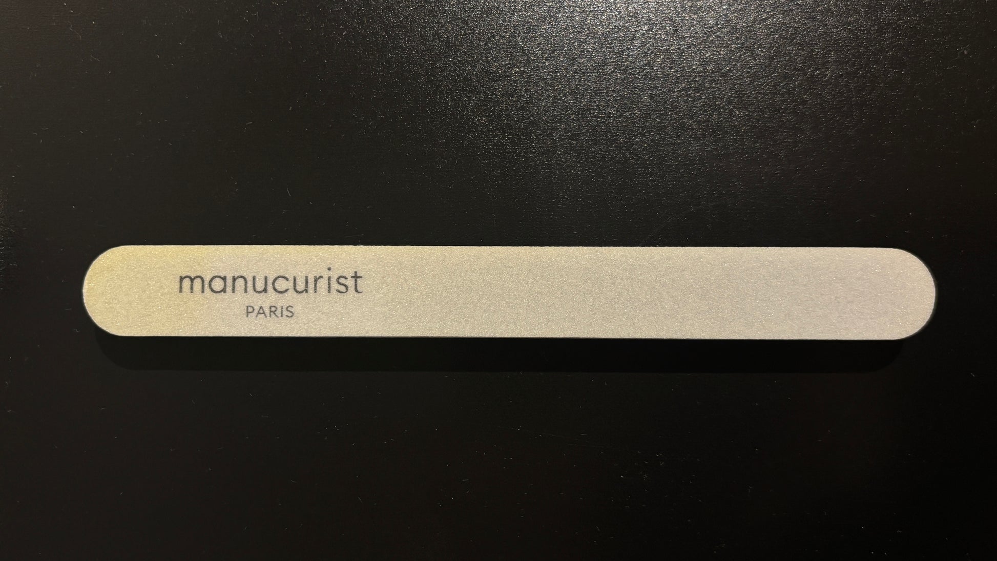 Image Manucurist Nail Buffer - top down view with logo