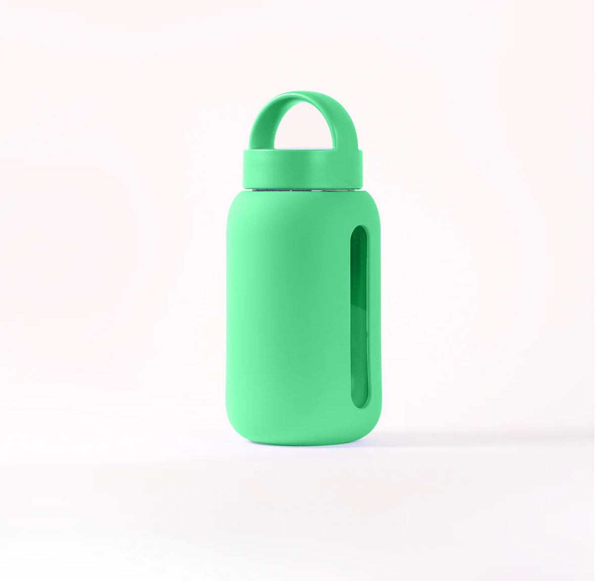 A green mini glass water bottle with a carrying loop and a silicone band.