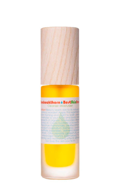 A clear bottle filled with yellow liquid, topped with a beige pump, labeled 'Best Skin Ever - Seabuckthorn'. Living Libations