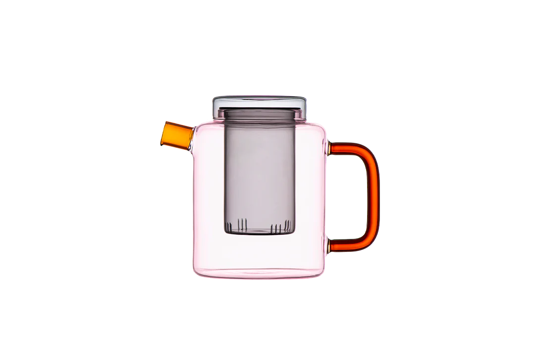 Clear glass pitcher with pink body and orange handles on a white background