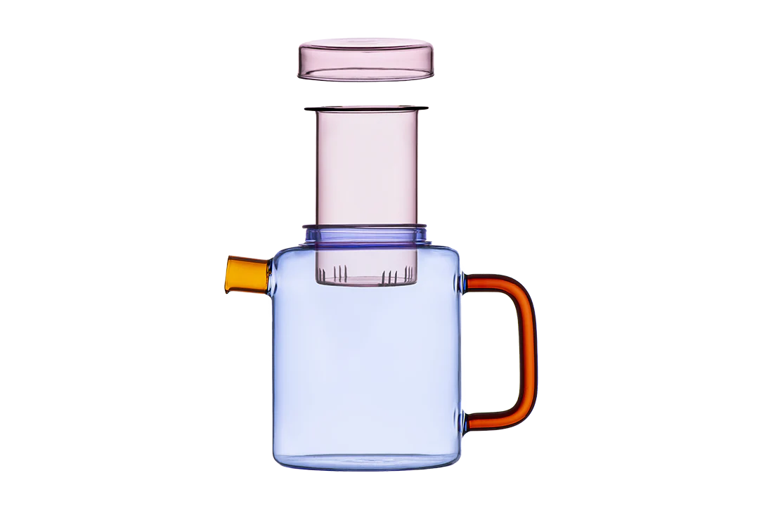 Clear glass container with a pink lid and orange handle on a white background