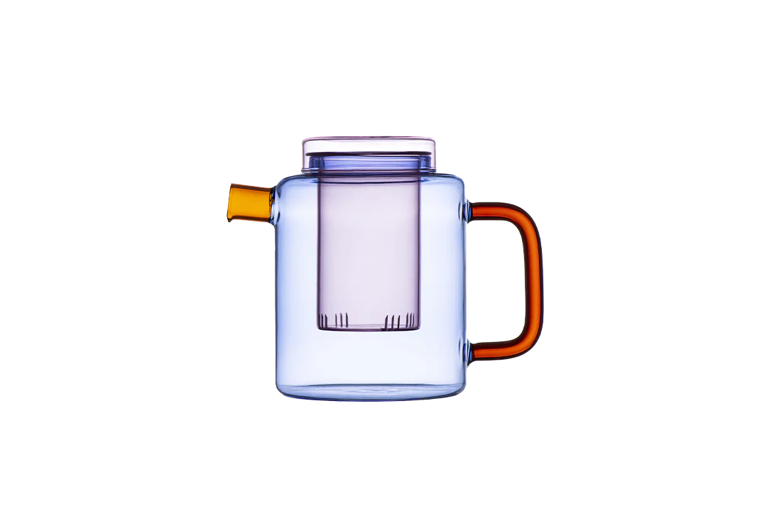 Clear glass pitcher with orange accents on a white background